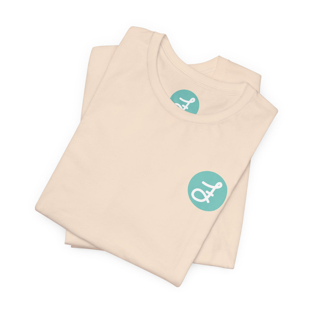 Frannie's Coffee Princeton, BC t-shirt in Soft Cream: folded, showing the F logo and printed neck label