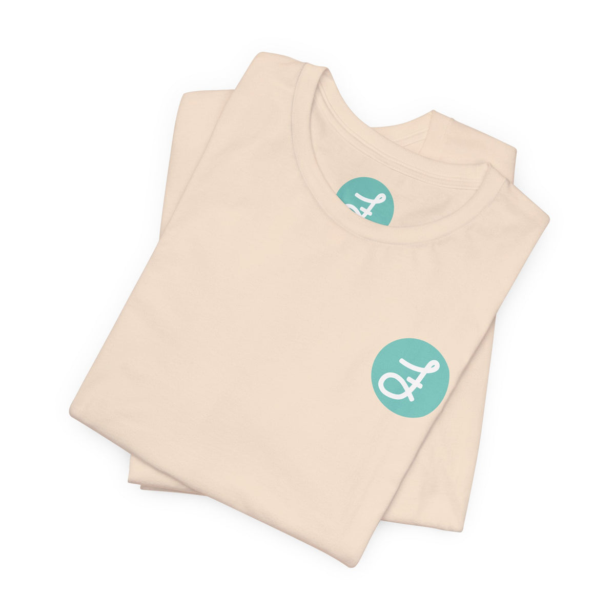 Frannie's Coffee Princeton, BC t-shirt in Soft Cream: folded, showing the F logo and printed neck label