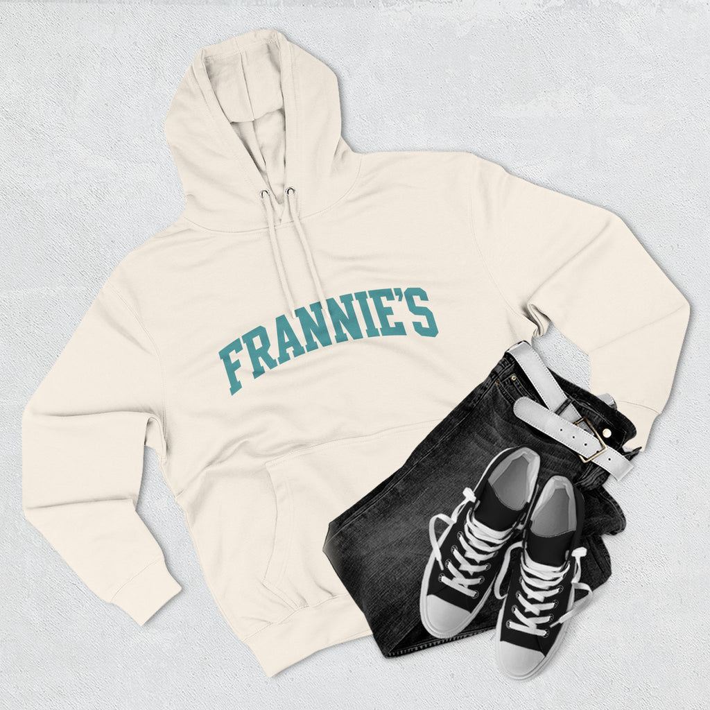 Frannie's varsity hoodie in Sandshell: laid flat with jeans and sneakers