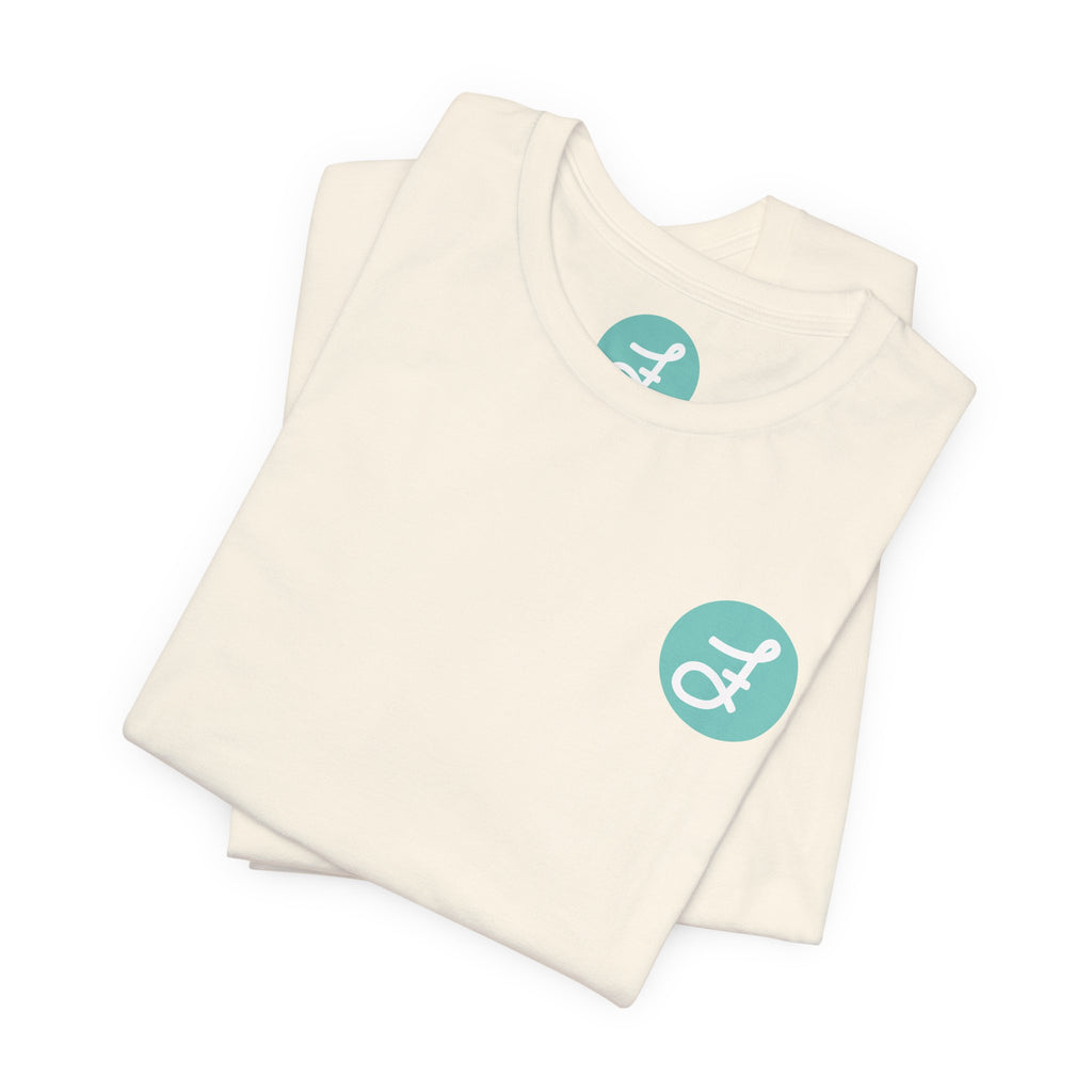 Frannie's Coffee Princeton, BC t-shirt in Natural: folded, showing the F logo and printed neck label