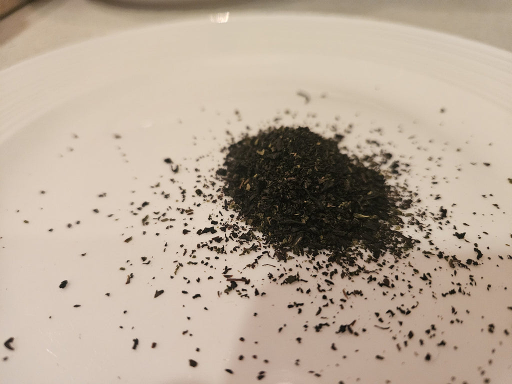 Premium Earl Grey loose tea leaves on a white plate