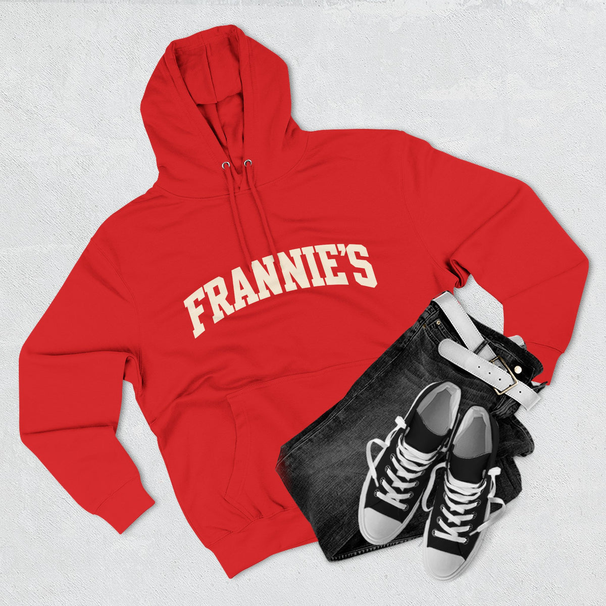 Frannie's varsity hoodie in Red: laid flat with jeans and sneakers