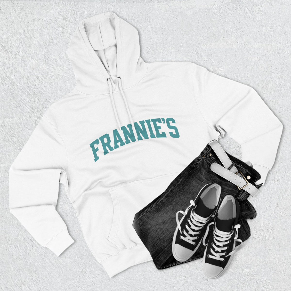 Frannie's varsity hoodie in White: laid flat with jeans and sneakers