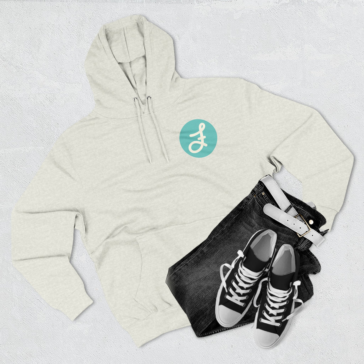 Frannie's Coffee logo hoodie in Oatmeal Heather: laid flat with jeans and sneakers