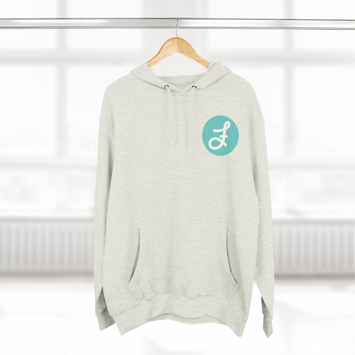 Frannie's Coffee logo hoodie in Oatmeal Heather: on a hanger