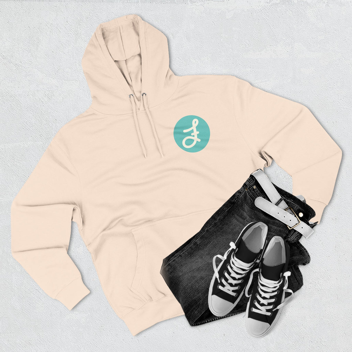 Frannie's Coffee logo hoodie in Pale Pink: laid flat with jeans and sneakers